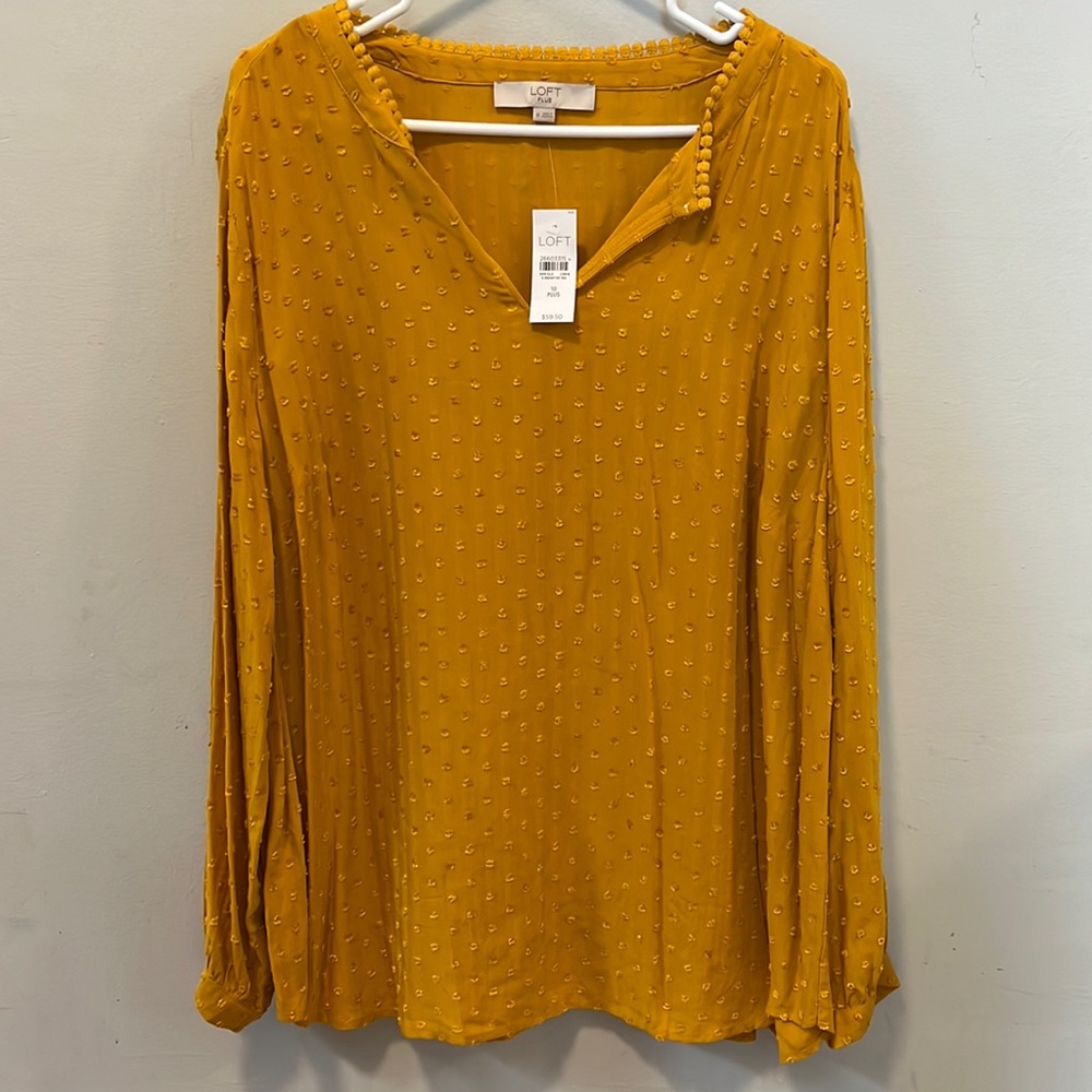 Yellow blouse, delicate pattern/texture. Keyhole neckline. Button long sleeves.